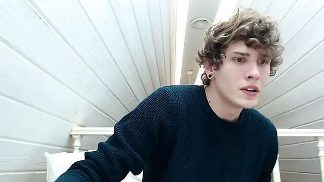 Handsome boy with curly hair cums