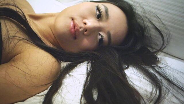 Asian adult model Estelle Lela Angels playes in bed